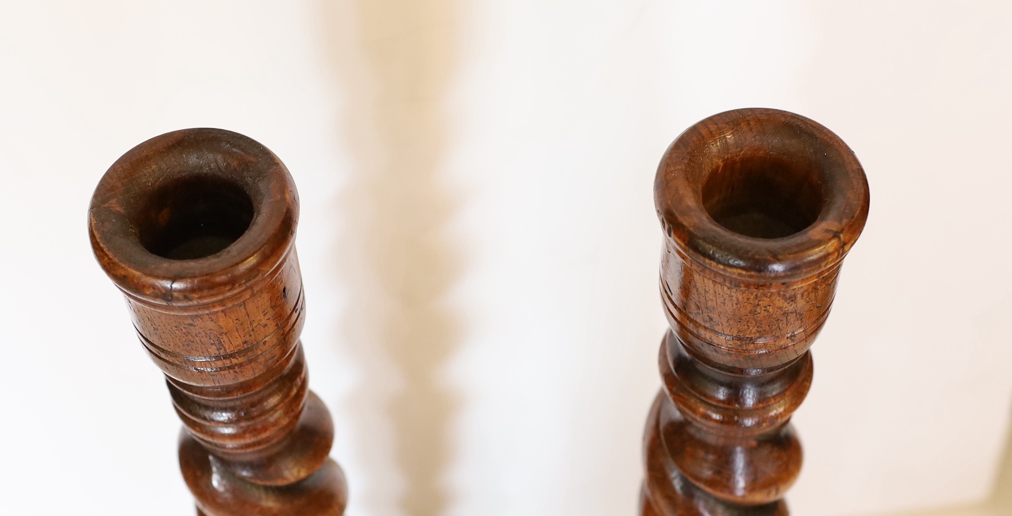 A pair of carved wood barley twist candlesticks, height 46cm